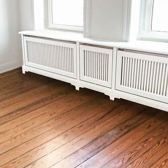 Tischlerei nipa Hamburg | weiße Holzverkleidung für Heizkörper nach Maß werten Immobilie auf